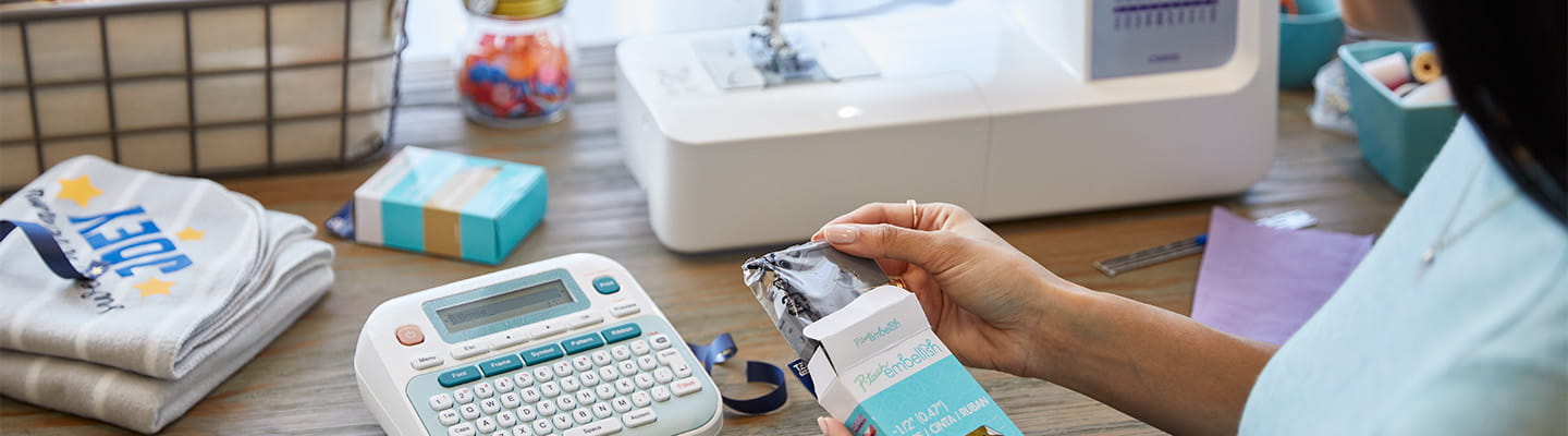 Ptouch and Brother sewing machine on a crafting desk