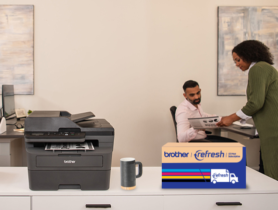 Brother Refresh Enabled printer on a cabinet with Refresh toner box next to it and two people working in the background. 