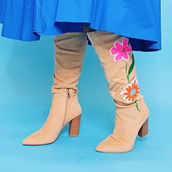 Knee-high boots with flower design embroidered on left boot