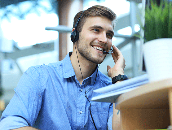 Customer service representative wearing headset and talking with customer