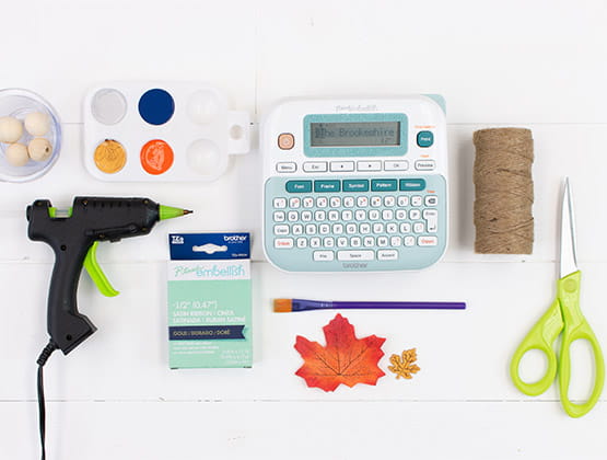Craft supplies with Ptouch label maker, hot glue gun and rope